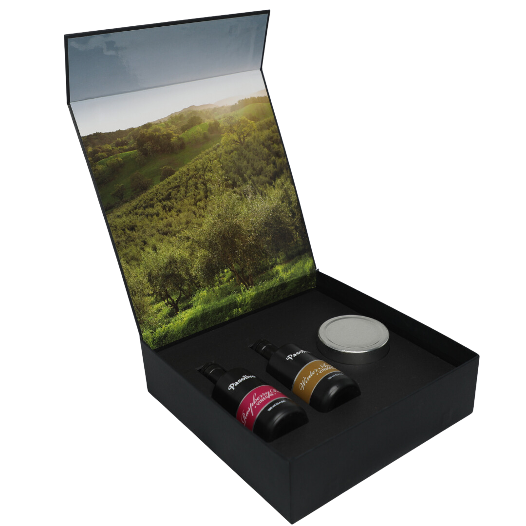 Premium Pasolivo products packaged in beautiful black box with green olive orchard imagery.