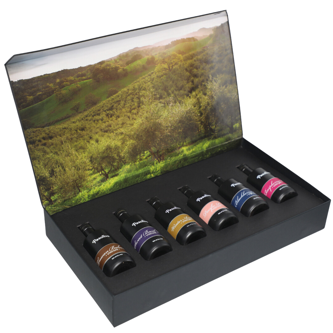 Premium Pasolivo products packaged in beautiful black box with green olive orchard imagery.