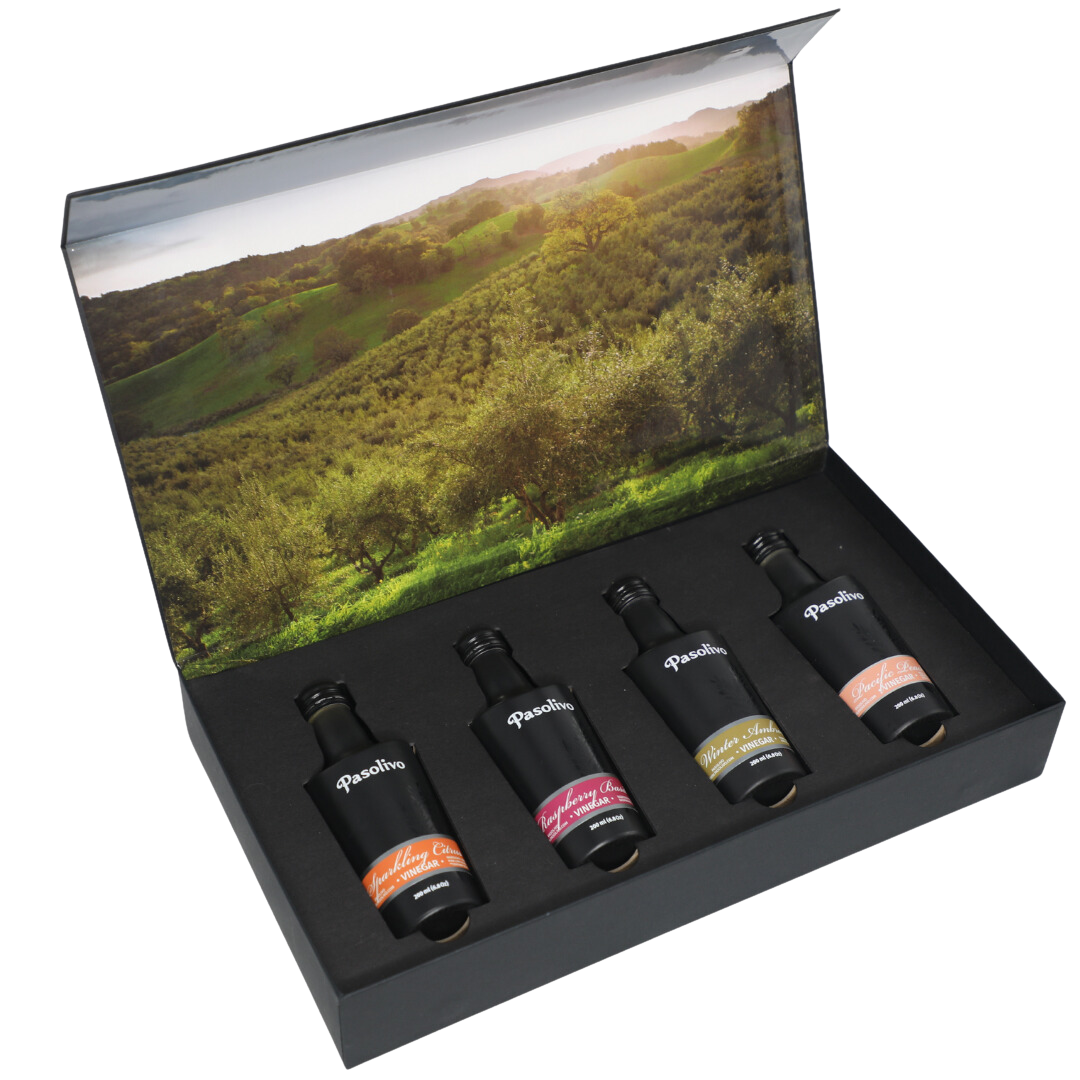 Premium Pasolivo products packaged in beautiful black box with green olive orchard imagery.