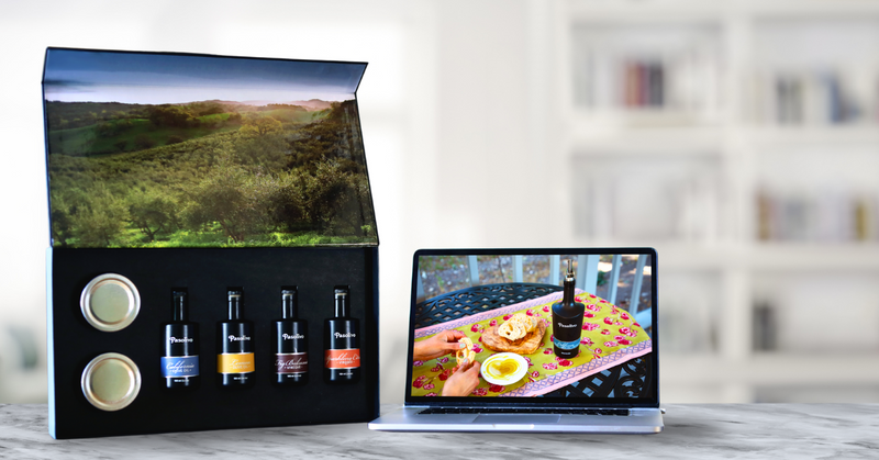 Packaging with bottles and a laptop displaying a scenic view and food.