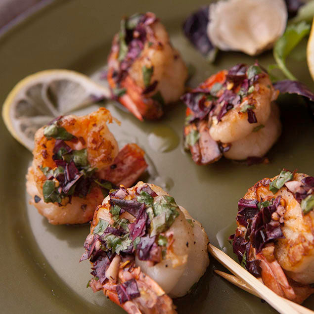 Pasolivo Shrimp with Thai Lemon Basil Vinaigrette Recipe plated with garlic cloves